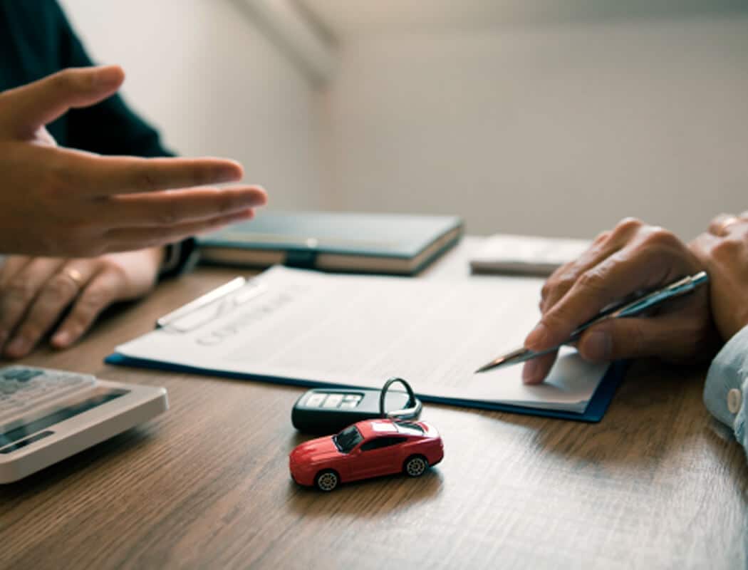 Henderson Car Title Loan Company Helping Client Sign Papers
