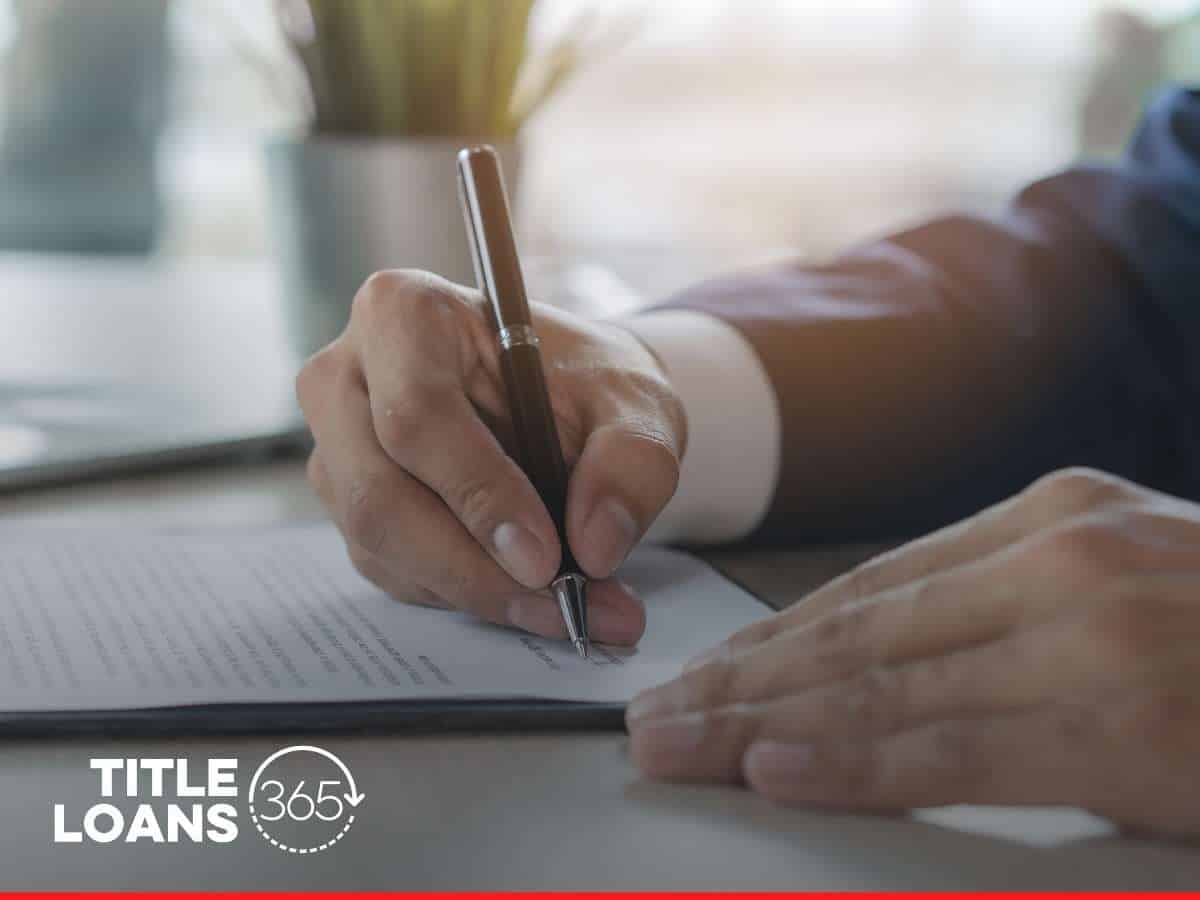 Signing documents for Low-Interest Title Loans at Title Loans 365.