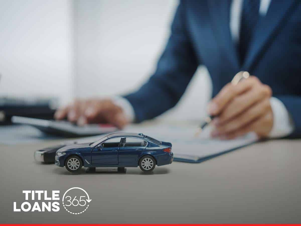 Signing paperwork for a Car Title Loan